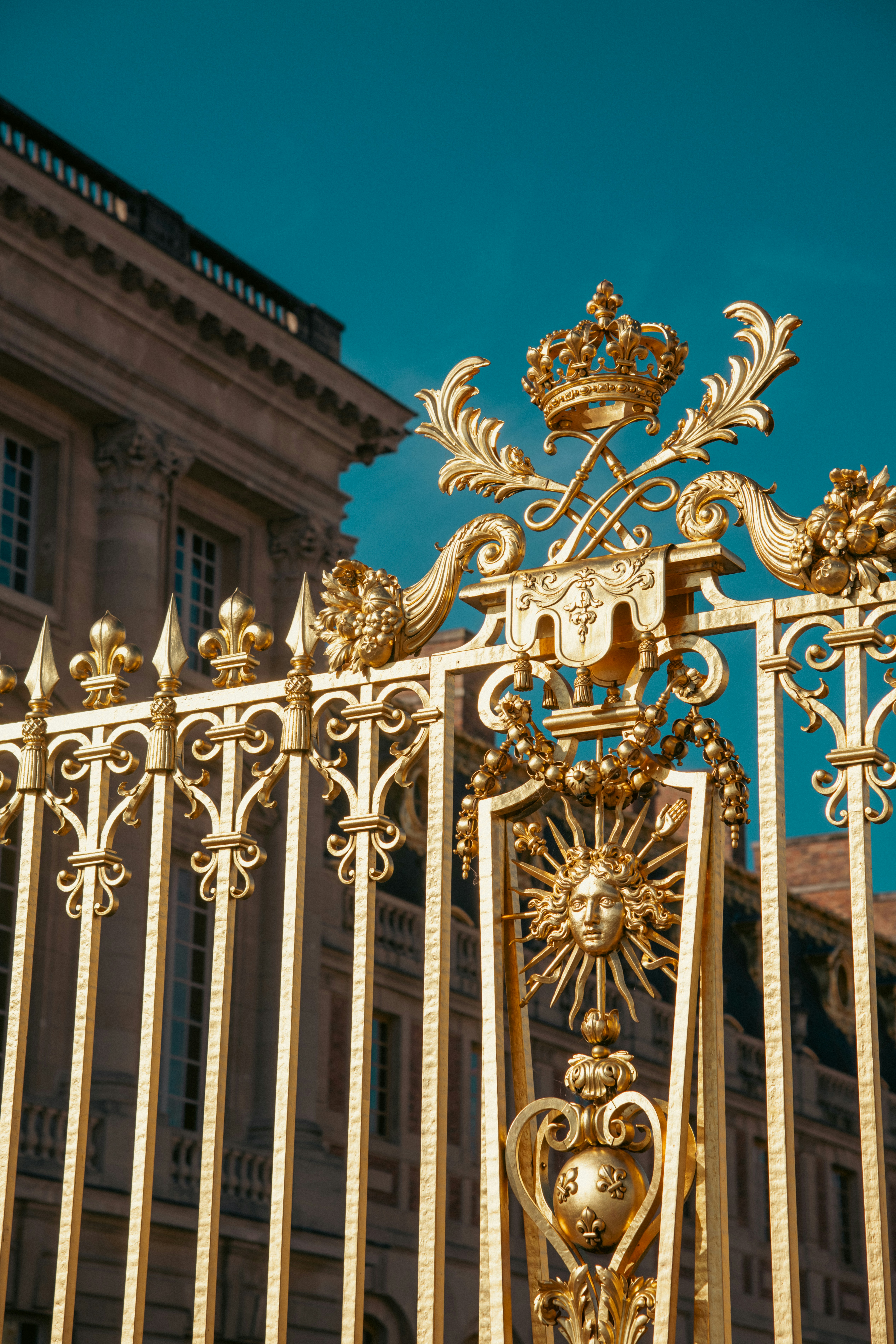 a golden gate with a clock on top of it